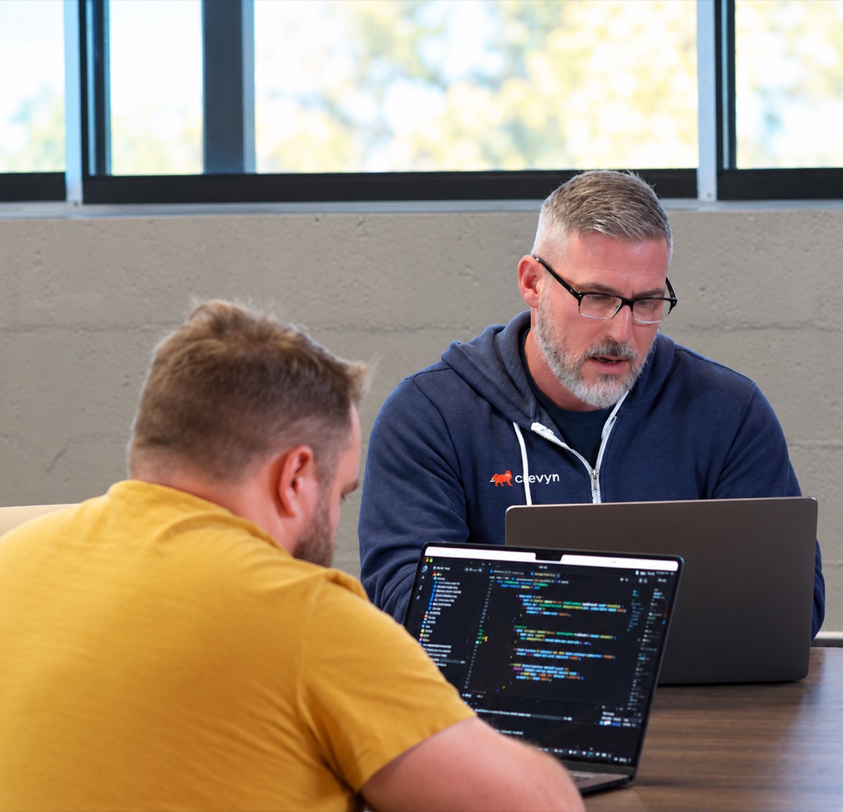 Two Clevyr engineers working through code together at the Oklahoma City office